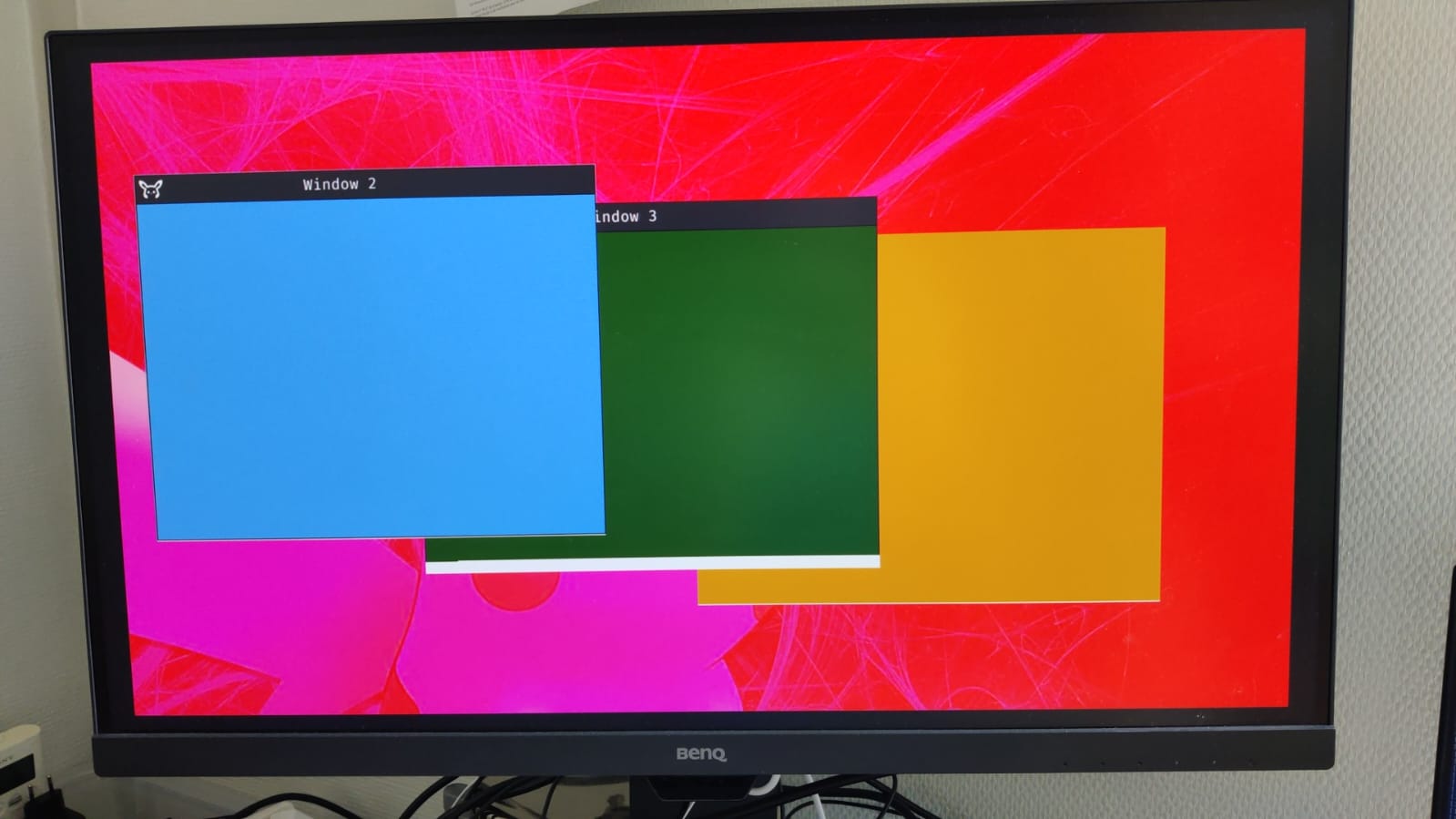 Photo of three windows displayer by our OS window manager on a screen.